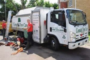 Two staff unloading equipment from a Connick Tree Care lorry