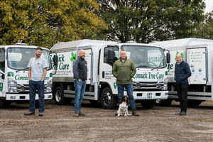 members of staff posing with Connick Tree Care branded lorries