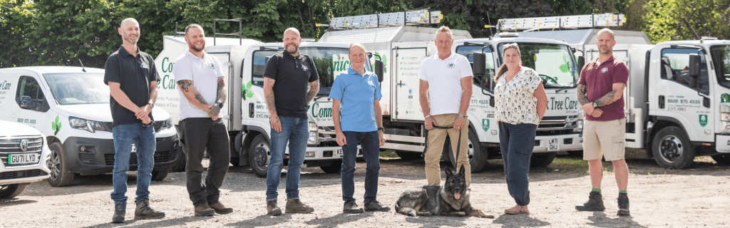 Photo of the 7 senior managers at Connick Tree Care, plus Rex the dog