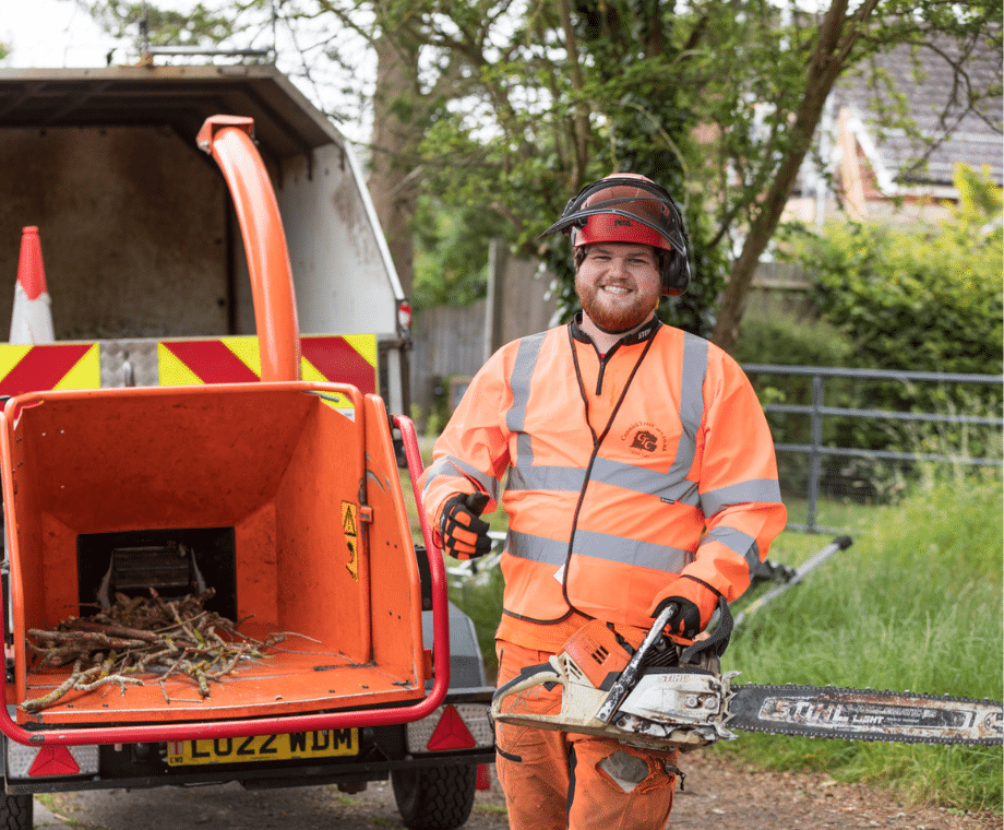 Connick Tree Care Tree Surgeon holding chain saw. Alkylate Fuel for Cleaner, Safer Tree Care