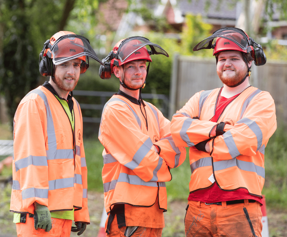 Three Connick Tree Care Arborists smiling. What Qualifications Should a Tree Surgeon Have in the UK